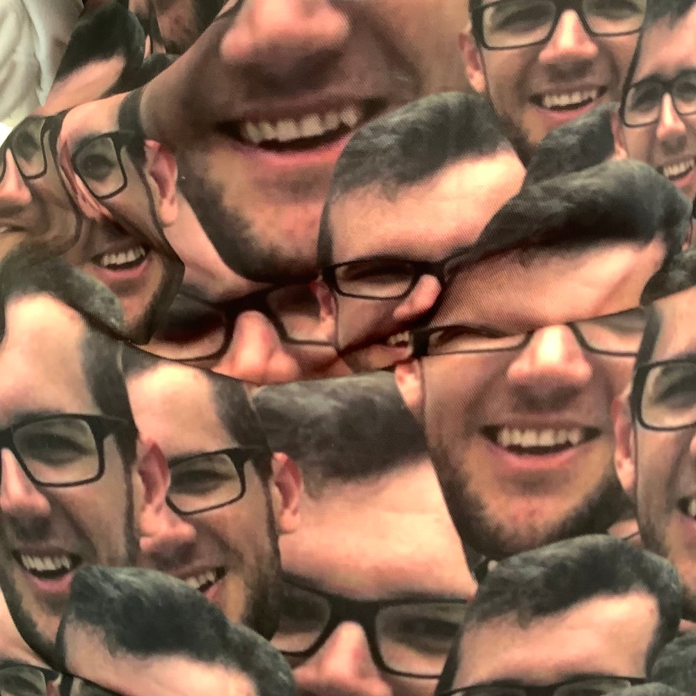 male face of husband to be pattern on an apron worn by the bride to be closeup