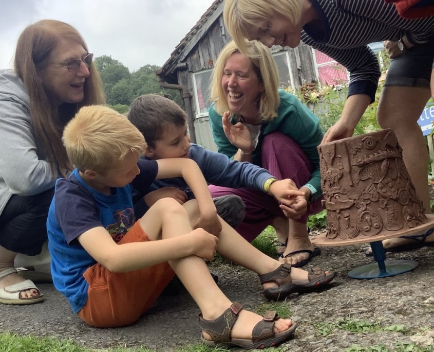 70th birthday party admiring the group pot they made at eastnor pottery in herefordshire