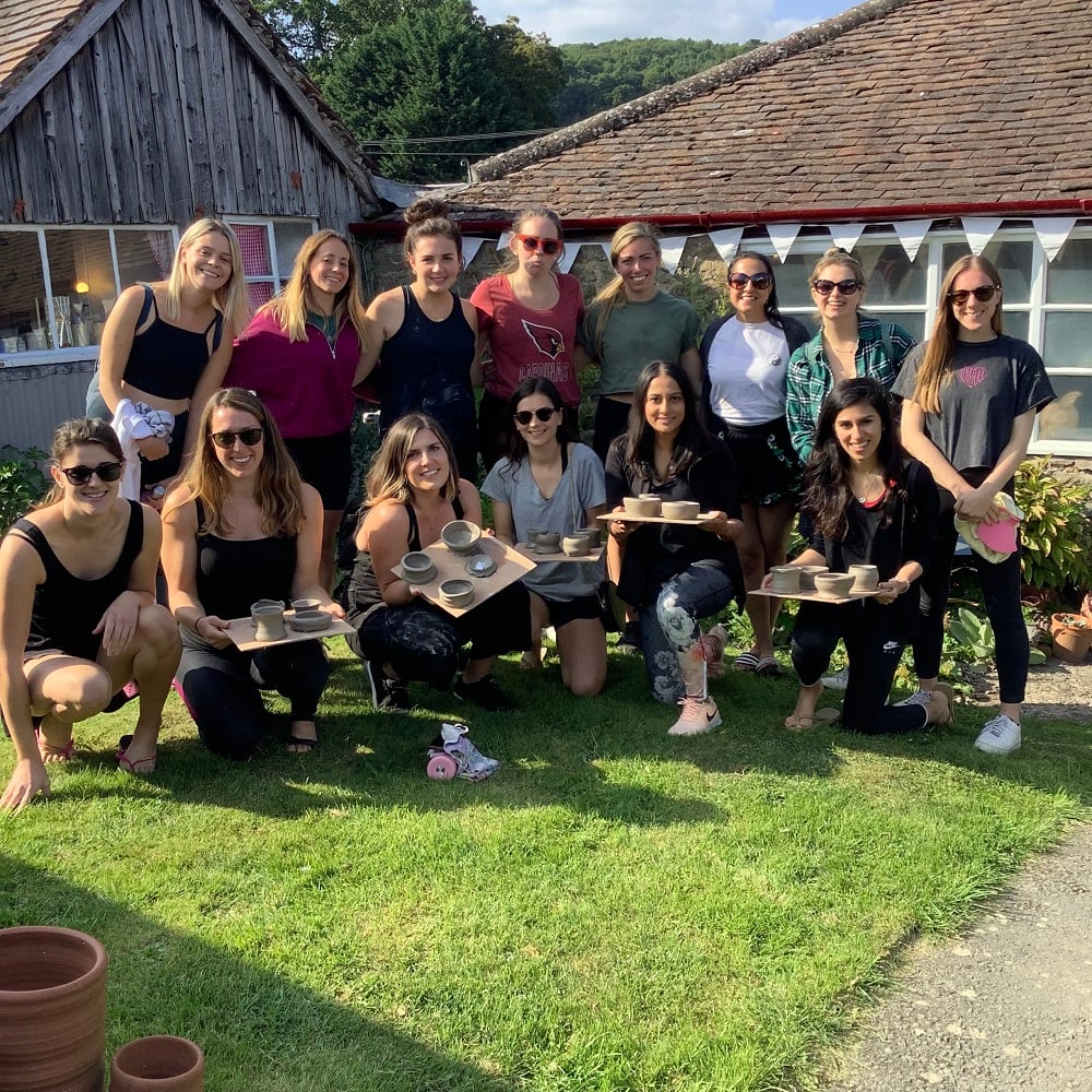 rosys hen party displaying their freshly thrown pots in the garden at eastnor pottery