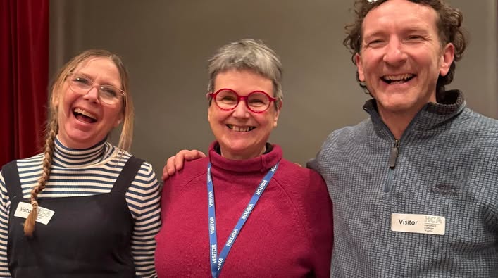 Sarah monk, Felicity Ayleiff and Jon Williams, reunited! Standing together, arms around each other's shoulders looking happy and staight at the camera.