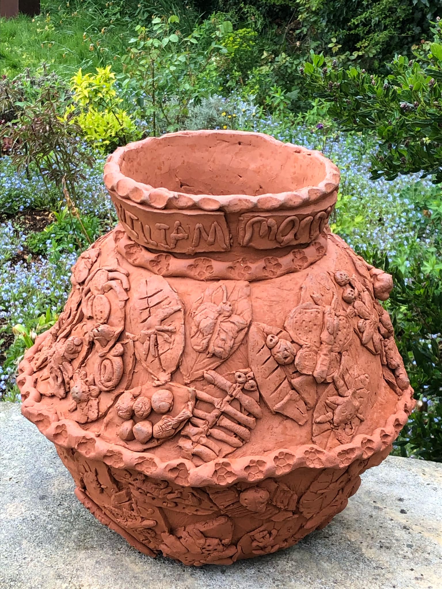 collaborative coil pot made with william morris primary school and jon the potter from eastnor pottery for sculpture at kingham lodge. the pot is encrusted with the children's modelled leaves lots of texture and patterns