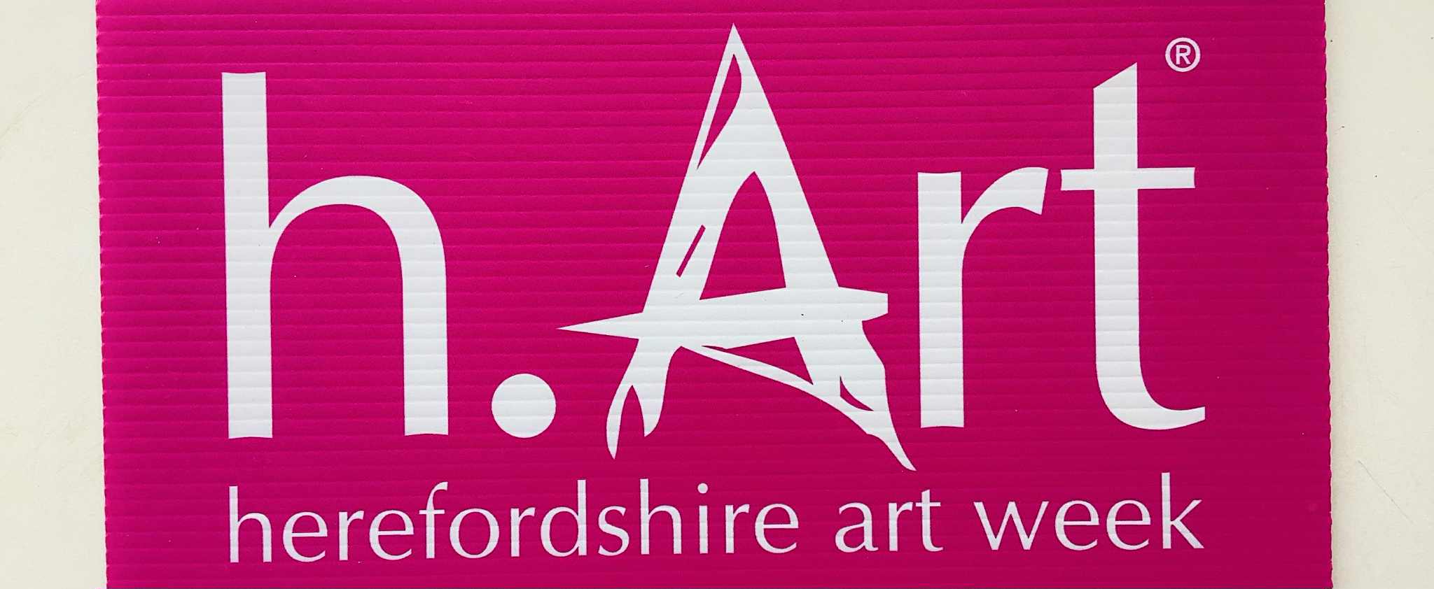 Bright pink background with white letter logo saying h.Art Herefordshire Art Week