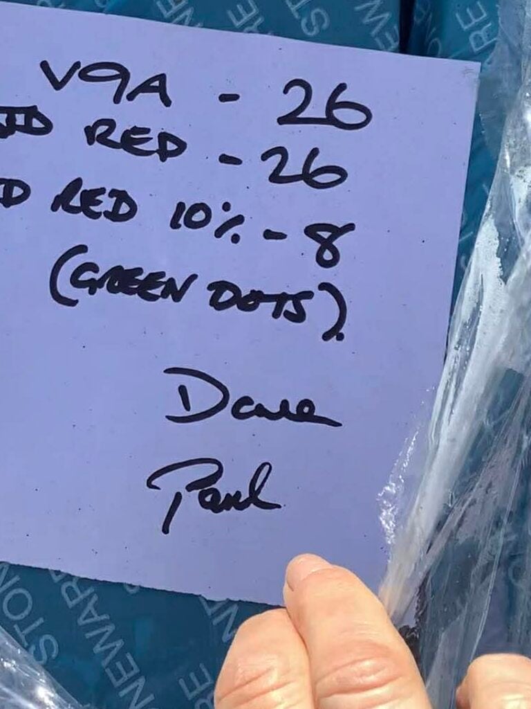 note from valentine clay products on top of a blue bag of clay. The note details the clay order and is signed by Dave and Phil