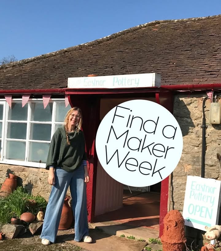A lady (Sarah Monk stood outside the door entrance to eastnor pottery, there is a find a maker logo set into the photo.