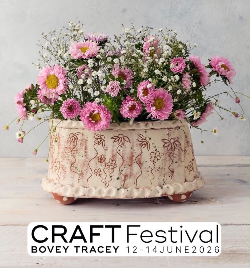 A pretty picture of a white, oval flower brick decorated with flowers. It also contains a huge arrangement of fresh, pink asters.