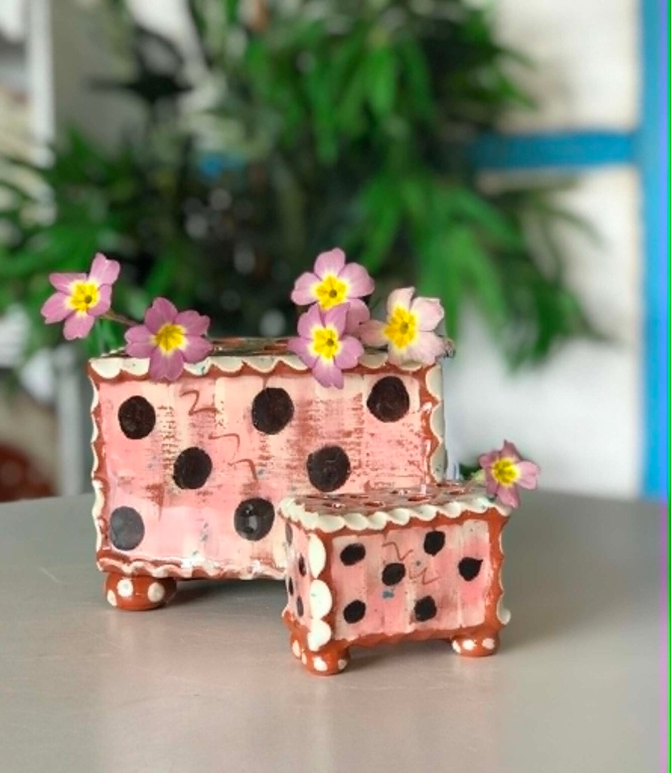 Two pink flower bricks; one medium, one small.