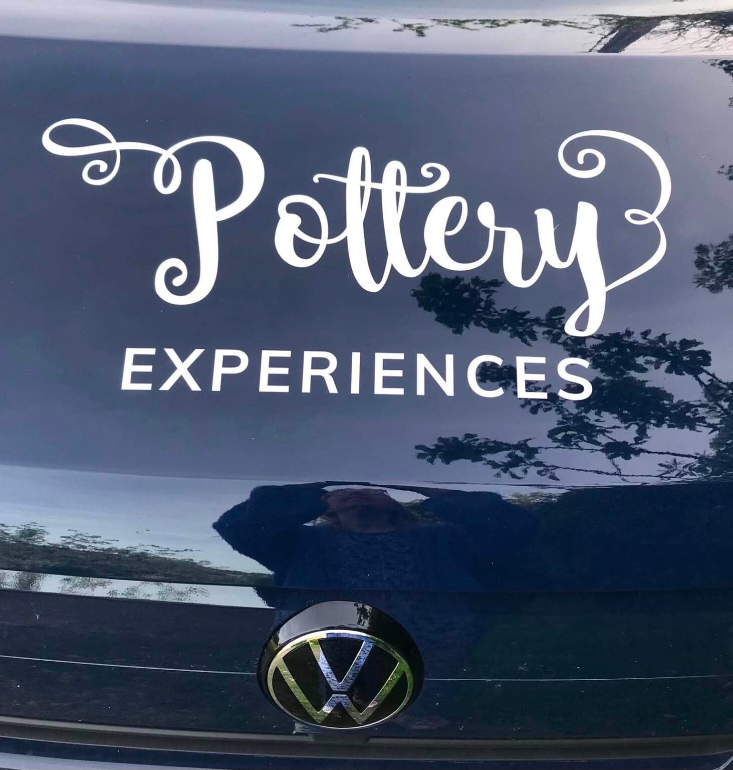 The top of the van bonnet with the words Pottery Experiences in scrolled curly writing.