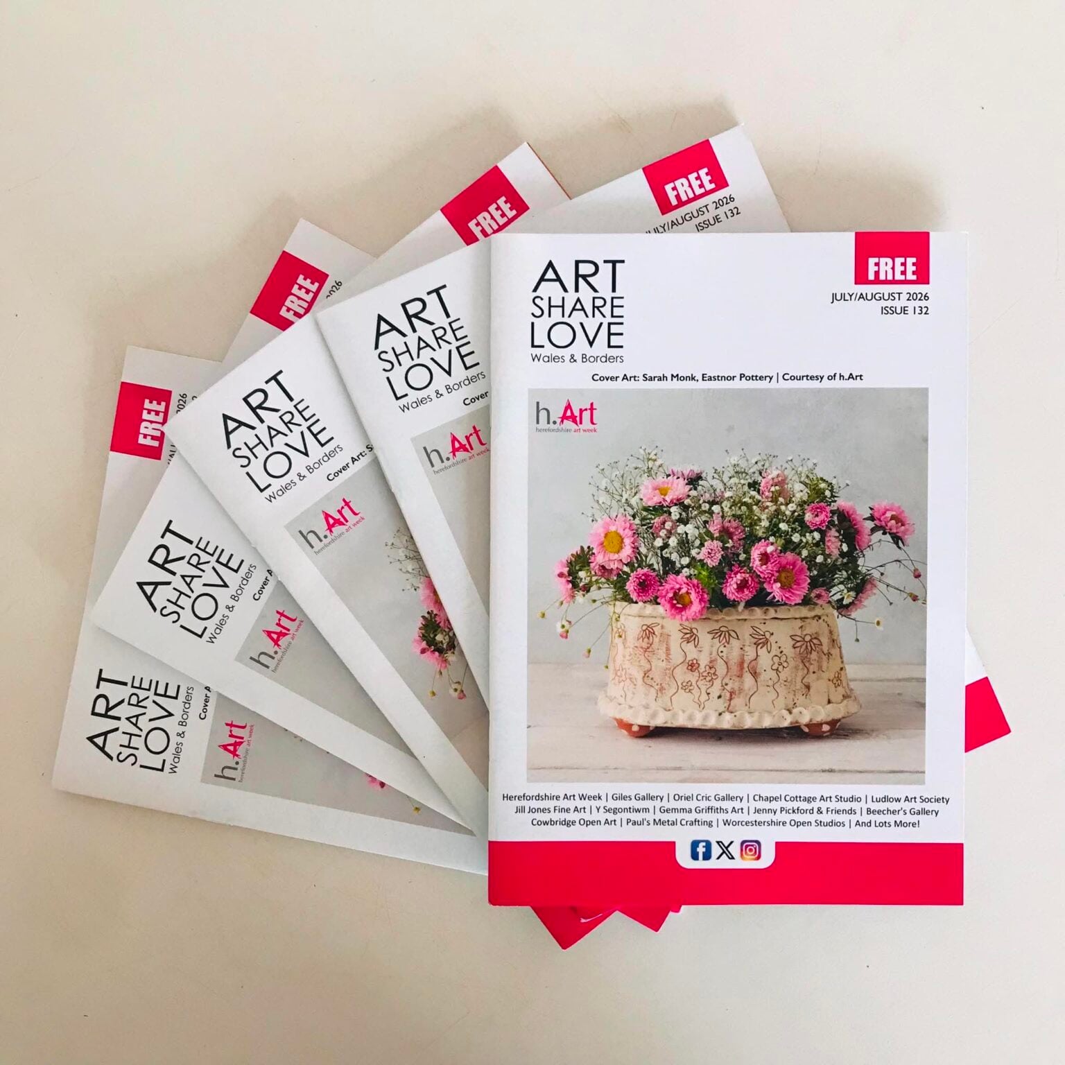 five closed copies of Art Love Share magazine featuring a large flower brick on the cover by potter sarah monk. The a5 magazines are laid out in a fan
