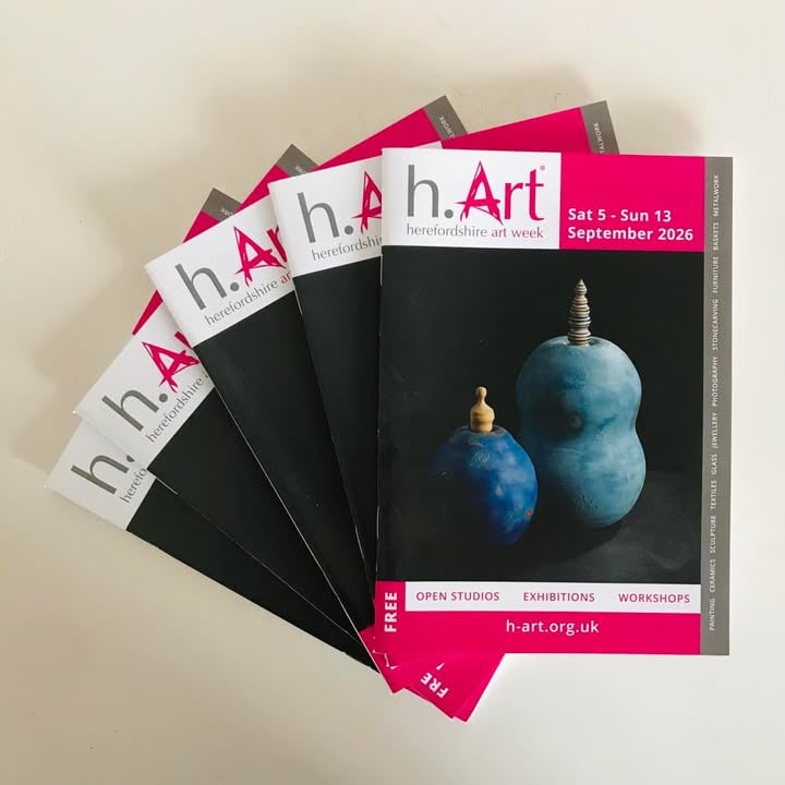 five closed copies of the Herefordshire Art Week guide featuring two pots by artist and potter jon williams on the cover. The a5 magazines are laid out in a fan.